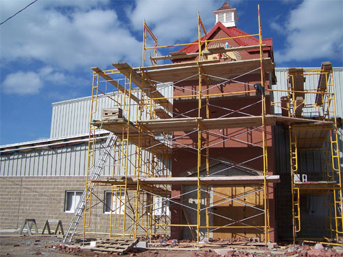 The new Acton Community Centre and Sports Building in Acton's Prospect Park. The building is still under construction and the clock tower has been put in place.