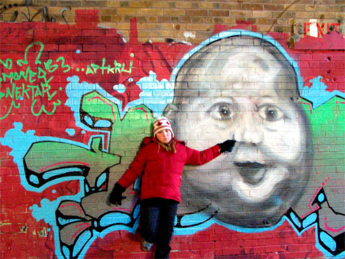 Toronto Don Valley Brickworks. Inside brick factory. Erin stands beside baby graffiti face.