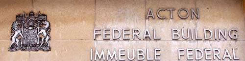 Acton's Federal building sign and coat of arms