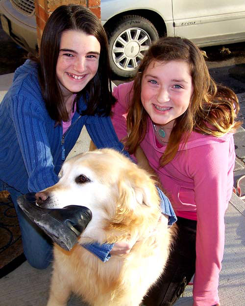Erin and Melissa with Sasha the golden retriever - Sasha has a shoe in her mouth