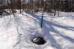 A Region of Halton sewer manhole peaks out of the snow