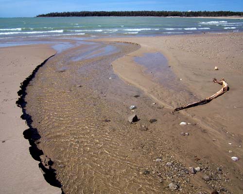 stream cuts through beach along Lake Huron