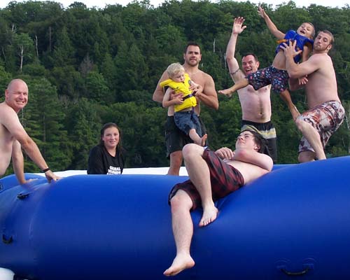 family on trampoline in the water