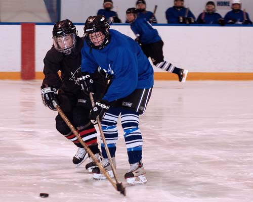 Acton Ladies Hockey Sharks vs Lightning battle for the puck - 2009 championship game