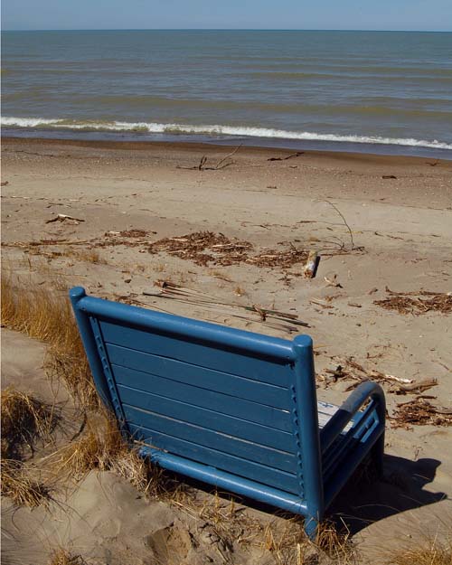 oversize blue chairs on beach at Kincardine, Ontario looking over Lake Huron