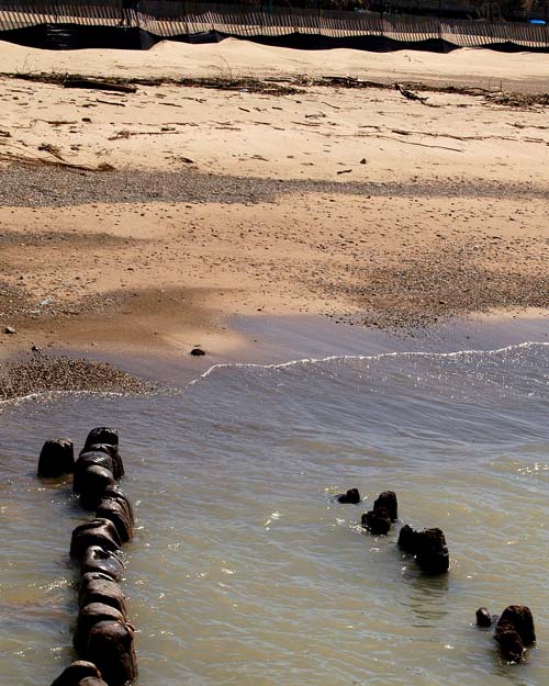 Old pier posts remain in the beach at Kincardine, Ontario in Lake Huron