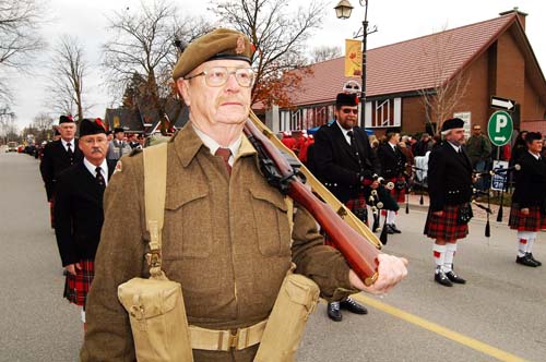 Acton Remembrance Day Parade. Soldier in second world war uniform with rifle